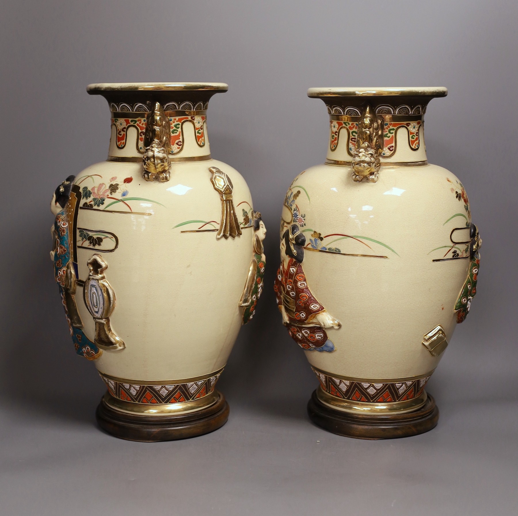 A pair of large Satsuma vases with relief decoration and dragon handles, 35cm tall with bases